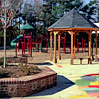 Playground Comfort/Social Zone with a gazebo, benches, and brick planter seating