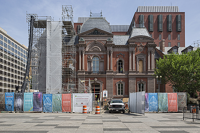 Exterior of the Renwick Gallery, Smithsonian American Art Museum with scaffolding and protective screening installed during construction.