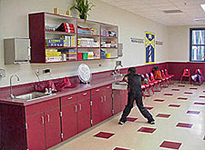 Child in front of red cabinets in the arts-and-crafts-style activity room at the youth center, naval station Mayport