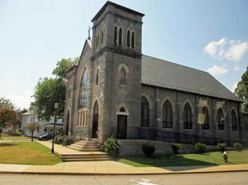 Exterior photo of historic church with an accessibility ramp placed along the side of the building