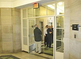 lobby with interior open stair doors retrofitted with rated glass for fire and smoke separation