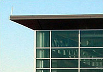 top of a building specfically the building overhang with clean, straight lines and glass windows