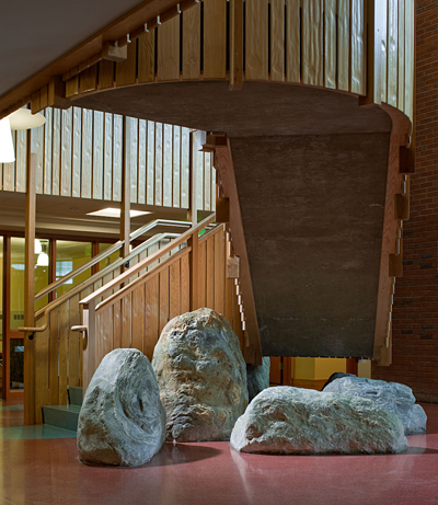 Local boulders found on the construction site anchor the building to the Earth and offer casual locations for students and faculty to pause