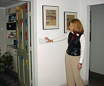 woman operating a lightswitch in her workplace