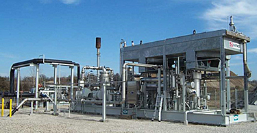 Photo that shows a landfill gas treatment station with a blower and flare.