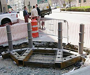 corner unit of four bollards placed inside excavation at construction site