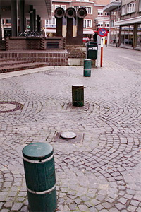 retractable bollards along a pavered street