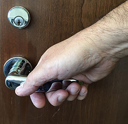 hand operating a levered door handle