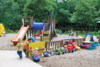 playground with a mix of sand play area, hard surface zone, and gross motor skills area