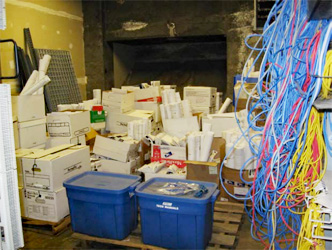 photo of a storage room full of boxes and bins depicting the typical delivery of handover documents