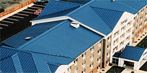 aerial photo of buildings with blue metal sloping roofs