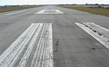runway coating with fatigue, alligator and block cracking, raveling and weathering, reduction of AC cover