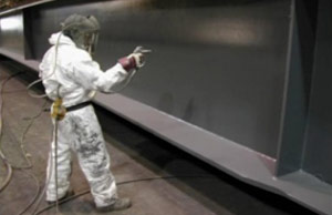 Photo of worker spraying coating on surface