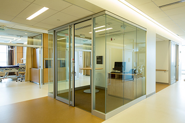hallway with glass-walled room for computer at Christ Hospital Joint and Spine Center