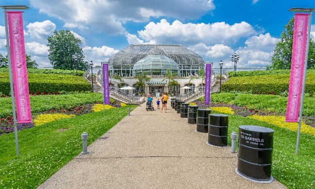 Entrance to Phipps with 16 oil barrels along the sidewalk