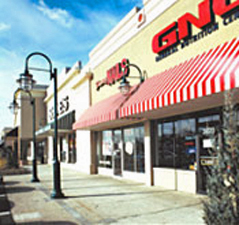 Storefronts like GNC along the sidewalk