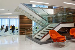 Example of interior design and lighting design featuring a modern staircase and red chairs