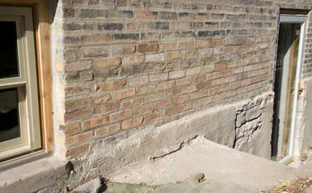 Photo of exterior building wall with sacrificial parging layer