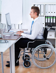 man in wheelchair at computer
