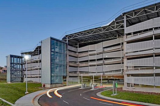 NREL garage at the US Department of Energy Laboratory includes a state of the art solar array.  It is exposed structural and architectural steel including a center light well for natural daylighting.