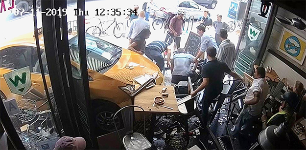 security camera still of vehicle crash into restaurant patio and dining area in New York City