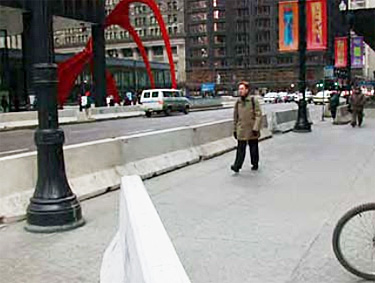 street view with concrete barrier for pedestrian traffic