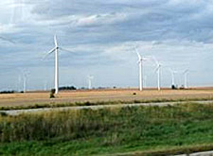 Wind turbines in a field along side a road