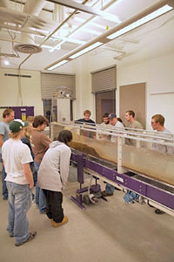 Students gathered around a geology flume lab