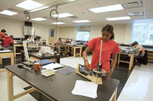 Multiple, flexible table configurations in a lab with students working at dedicated stations with lab equipment.