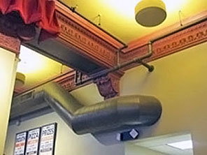 highly ornamented trim work with utility ducts and pipes installed over it which do not meet the Sectretary's standards