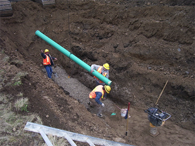 Workers constructing pipeline